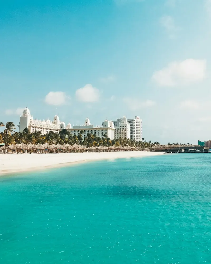 a view of a beach with a hotel in the background