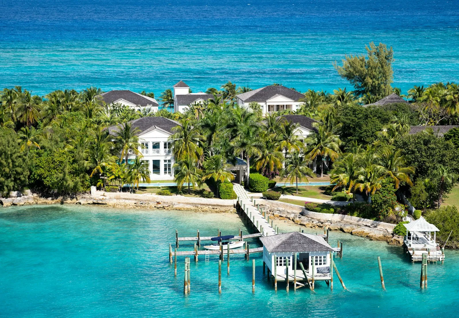 an aerial view of a tropical island with a dock