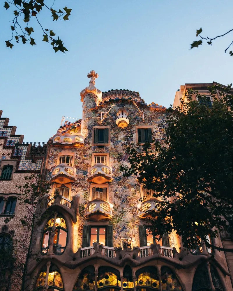The ornate facade of Casa Batllo with mosaic tiles in Barcelona, Spain