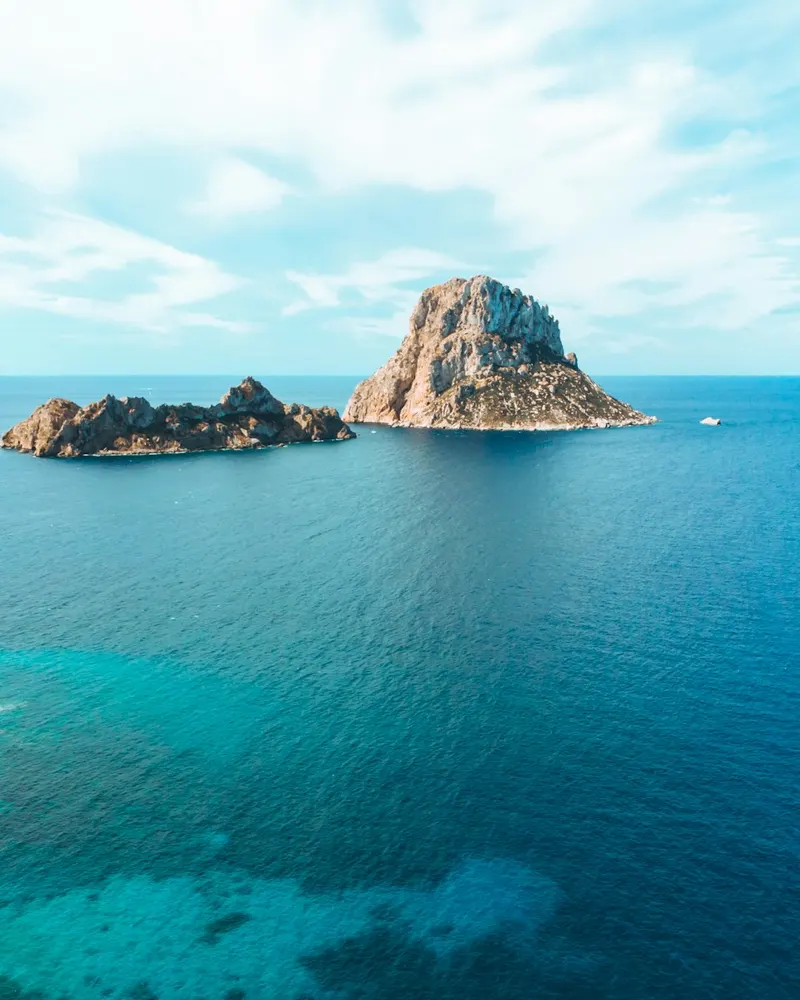 gray and brown rock formation on blue sea under blue sky during daytime