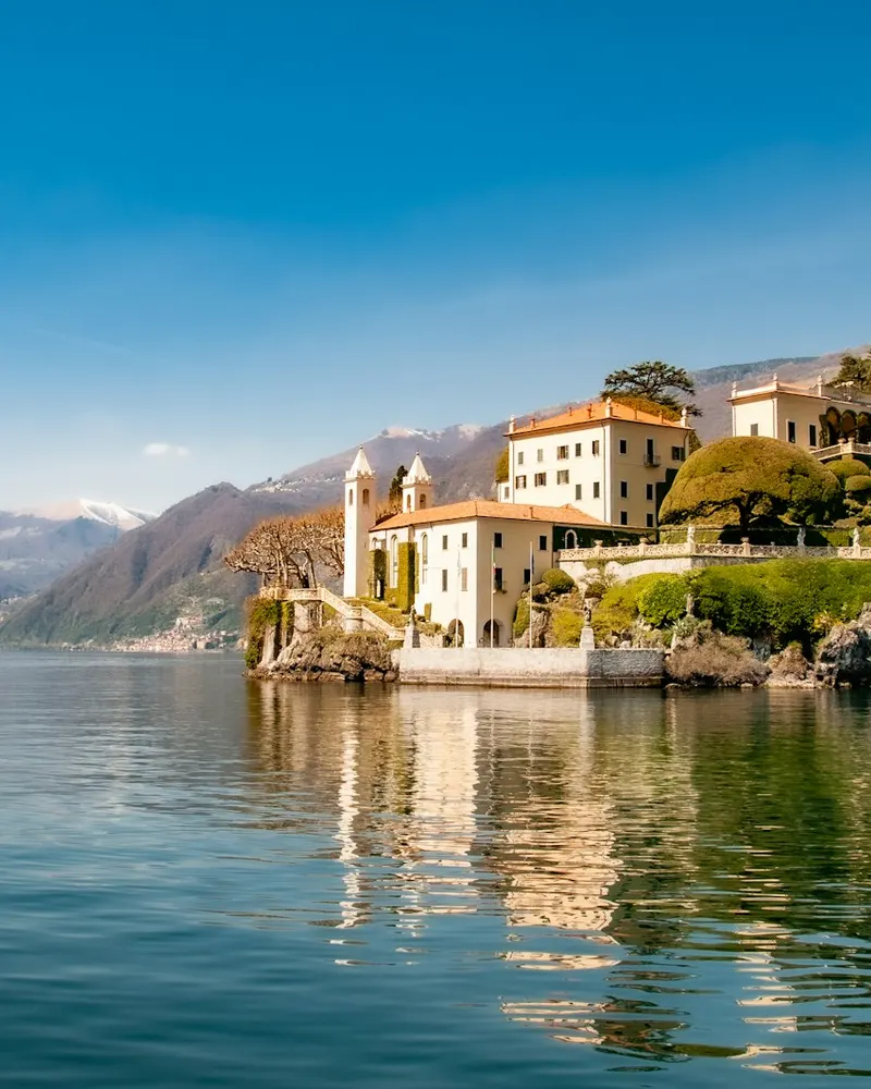 white concrete building near body of water during daytime