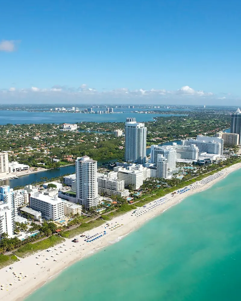 An aerial view of the coastline and high-rise buildings in Miami Beach, Florida