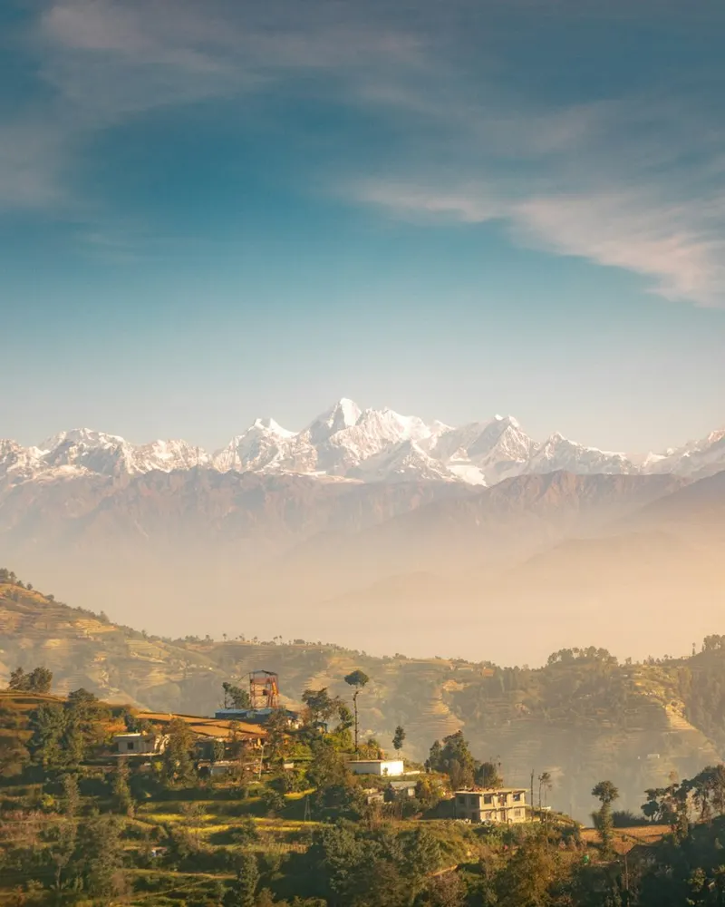 green trees and mountains under blue sky during daytime