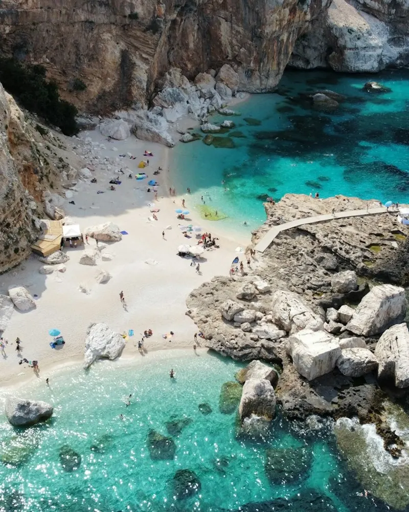 a group of people on a beach next to a body of water
