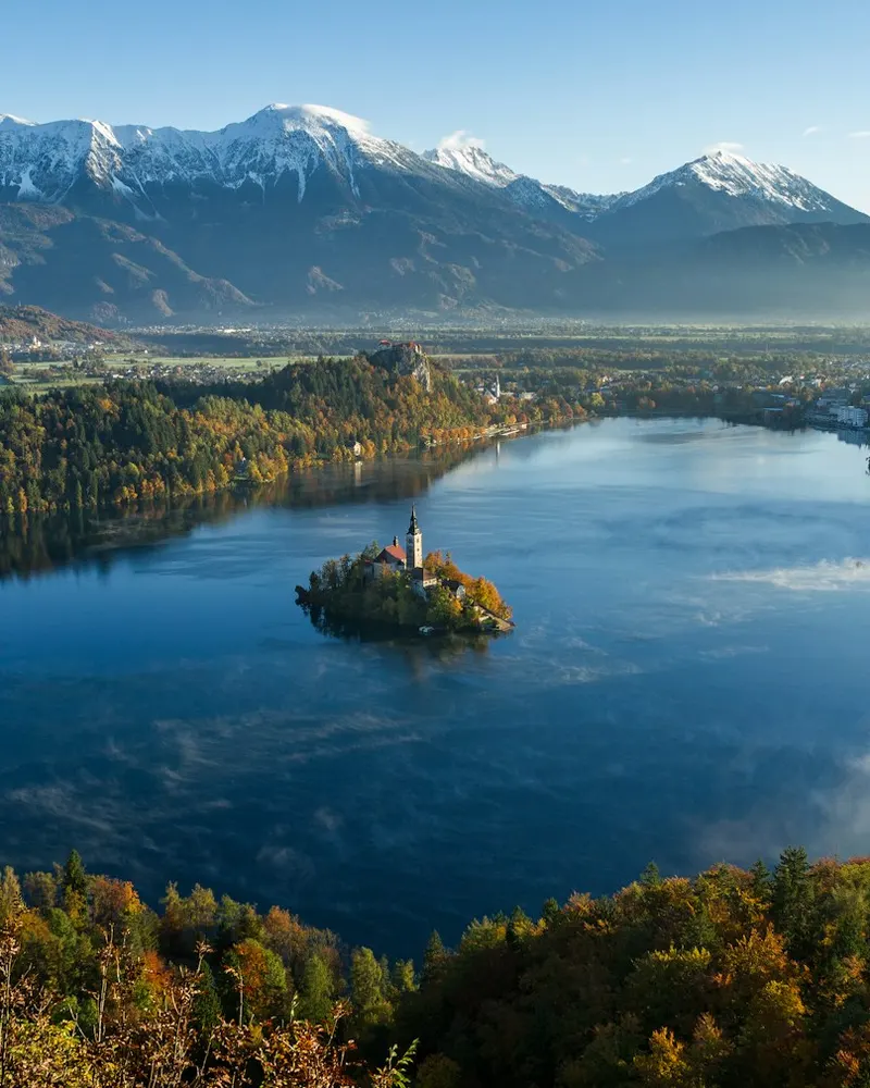 island surrounded by water and mountains at daytime