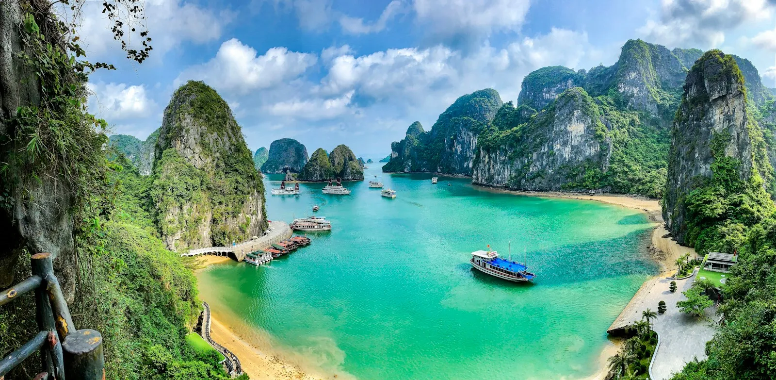 Boats on the turquoise water of Ha Long Bay surrounded by limestone karst islands